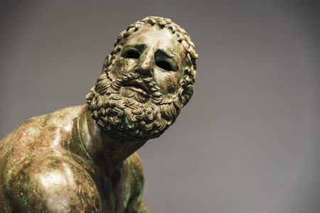 Roman bust or statue made with bronze of a human face called The fighter of the thermal bath or pugil at rest in Rome, Italyの写真素材