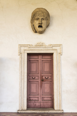 Roman statue of a human face with open mouth in Rome, Italyの写真素材