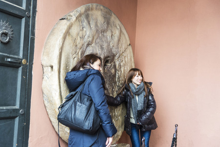 Rome, Italy - January 2, 2017: La Bocca della Verita (The Mouth of Truth) with two girls in the portico of the church of Santa Maria in Cosmedin in Rome, Italyのeditorial素材