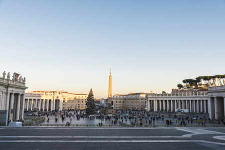 Tourists and a fir decorated with Christmas decoration at Saint Peter's Square in Vatican City, Vaticanの写真素材