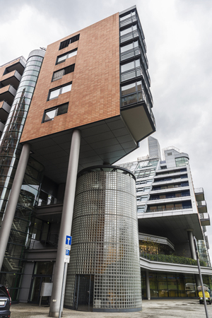 Grass lawn with modern apartment buildings and offices at your sides in Berlin, Germanyの写真素材
