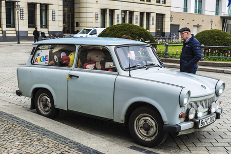 Berlin, Germany - April 12, 2017: Car of Trabant brand with its driver in front of Brandenburg gate called Trabi Andy full of teddy bears in Berlin, Germanyのeditorial素材