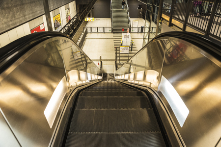 Berlin, Germany - April 12, 2017: Escalator in Bundestag underground station with people walking in...