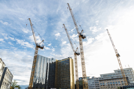 Berlin, Germany - April 13, 2017: Four construction cranes working on the construction of a skyscraper in Berlin, Germany.のeditorial素材