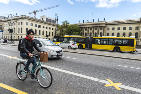 Berlin, Germany - April 13, 2017: Young cyclist among the traffic on a street of the Museum Island of Berlin, Germany.のeditorial素材