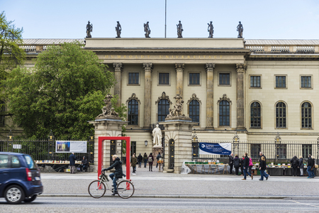 Berlin, Germany - April 13, 2017: People walking and a young cyclist among the traffic on a street of the Museum Island of Berlin, Germany.のeditorial素材