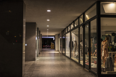 Hallway with clothes shops illuminated at night in Berlin, Germanyのeditorial素材
