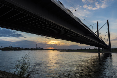 View of Oberkassel bridge at sunset in Dusseldorf, Germanyの写真素材