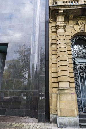 Facade of a modern building near an old classic building in Dusseldorf, Germanyの写真素材
