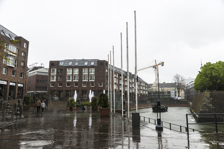 Dusseldorf, Germany - April 16, 2017: Rainy day with a couple walking in Dusseldorf, Germanyのeditorial素材
