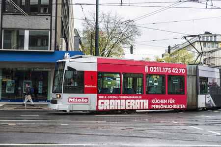 Dusseldorf, Germany - April 16, 2017: Tram with advertising by Miele and people walking  in Dusseldorf, Germanyのeditorial素材
