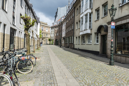 Dusseldorf, Germany - April 16, 2017: Cobbled street with bicycle parked in Dusseldorf, Germanyのeditorial素材