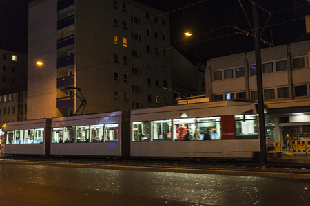 Tram with passengers at night in Dusseldorf, Germanyのeditorial素材