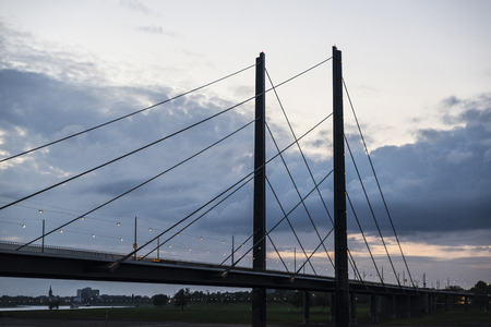 View of Oberkassel bridge at sunset in Dusseldorf, Germanyの写真素材