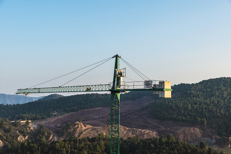 Cardona, Spain - October 31, 2016: Crane in a construction site next to the mountains in Cardona, Catalonia, Spainのeditorial素材