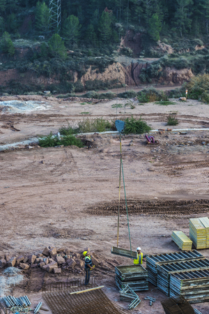 Cardona, Spain - October 31, 2016: Construction site with two workers driving a crane in Cardona, Catalonia, Spainのeditorial素材
