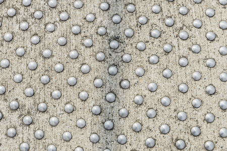 Closeup of a metal circles on a non-slip concrete surfaceの写真素材
