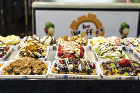 Brussels, Belgium - August 26, 2017: Assortment of traditional belgian waffle in the shop window of a candy shop in Brussels, Belgiumのeditorial素材