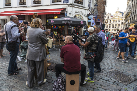 Brussels, Belgium - August 26, 2017: Band of street musicians and people walking on a street in Brussels, Belgiumのeditorial素材