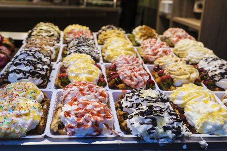 Assortment of traditional belgian waffle in the shop window of a candy shop in Brussels, Belgiumの写真素材