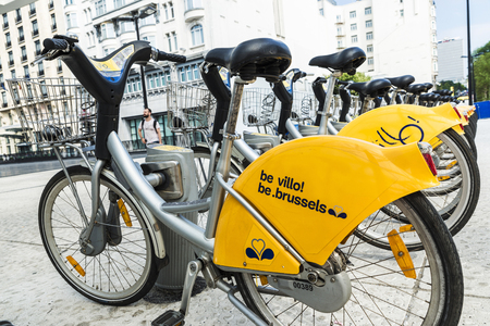 Brussels, Belgium - August 27, 2017: A row of rental bikes in their docking stands of the De Villo brand in Brussels, Belgiumのeditorial素材