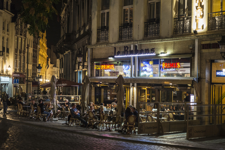 Brussels, Belgium - August 27, 2017: Street full of bars and restaurants with people walking at night located in the historic center of Brussels, Belgiumのeditorial素材