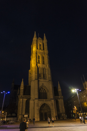 Ghent, Belgium - August 28, 2017: Facade of Saint Bavo Cathedral with people walking  at night in the old town of the medieval city of Ghent, Belgiumのeditorial素材