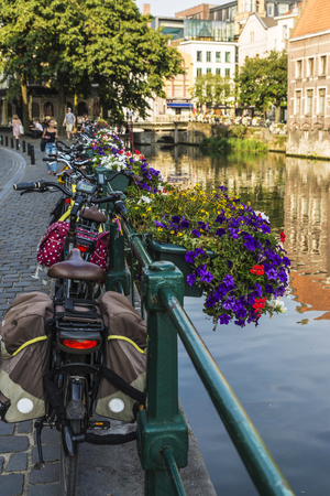 Ghent, Belgium - August 28, 2017: Parked bicycles and flower pot along the Leie river in the medieval city of Ghent, Belgiumのeditorial素材