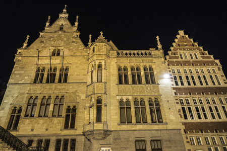 Facade of an old historic buildings at night of the medieval city of Ghent, Belgiumの写真素材