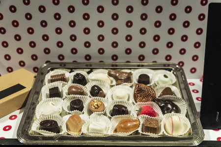 Assortment of traditional belgian chocolate in the shop window of a candy shop in the old town of the medieval city of Ghent, Belgiumの写真素材