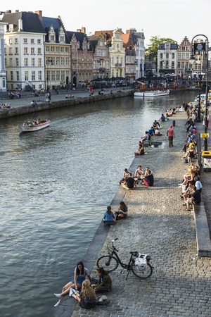 Ghent, Belgium - August 28, 2017: People having fun next to the river in the medieval city of Ghent, Belgiumのeditorial素材