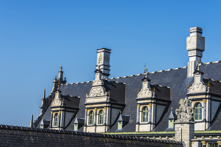 Sundial and windows on the roof of an old medieval house in the old town of the historic city of Ghent, Belgiumのeditorial素材
