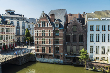 Ghent, Belgium - August 29, 2017: Old houses along the Leie river with people around in the medieval city of Ghent, Belgiumのeditorial素材