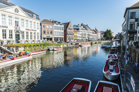 Ghent, Belgium - August 29, 2017: Old houses and boats along the Leie river with people around in the medieval city of Ghent, Belgiumのeditorial素材