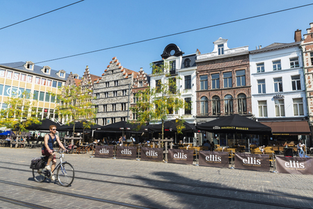 Ghent, Belgium - August 29, 2017: Young man on bicycle circulating and people walking in an old historic center of the medieval city of Ghent, Belgiumのeditorial素材