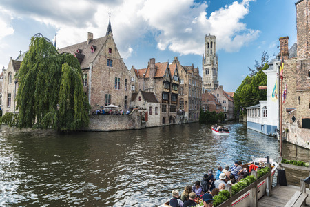 Bruges, Belgium, - August 31, 2017: Rozenhoedkaai or Rosary Dock with people sailing on a boat in the medieval city of Bruges, Belgiumのeditorial素材