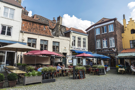 Bruges, Belgium, - August 31, 2017: Street with bars and restaurants with people having a drink in the medieval city of Bruges, Belgiumのeditorial素材