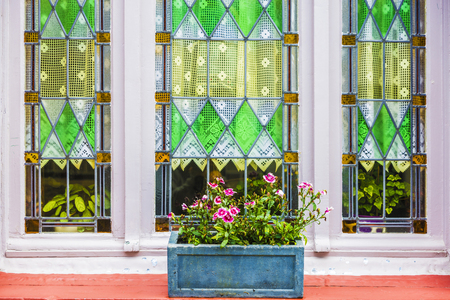 Window with flower pot of an old classic house in an old historic center of the medieval city of Bruges, Belgiumの写真素材