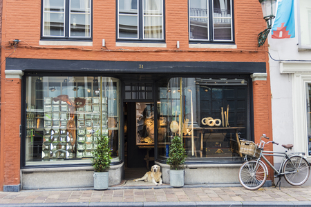 Bruges, Belgium, - August 31, 2017: Shop or art gallery with a dog resting in its entrance in the medieval city of Bruges, Belgiumのeditorial素材