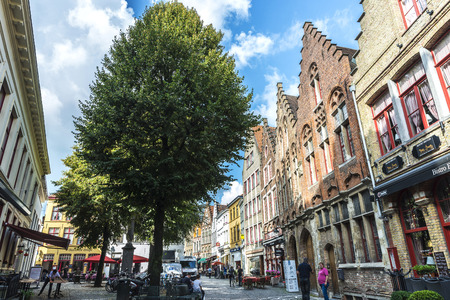 Bruges, Belgium - August 31, 2017: Street with bars and restaurants and people walking in the medieval city of Bruges, Belgiumのeditorial素材