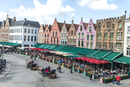 Bruges, Belgium - August 31, 2017: Old colorful traditional houses with bars and restaurants in the Grote Markt ( Market Square ) with people around in the historic center of the medieval city of Bruges, Belgiumのeditorial素材