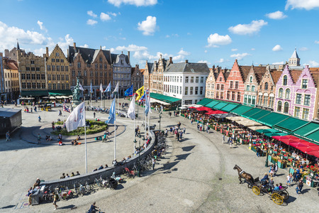 Bruges, Belgium - August 31, 2017: Old colorful traditional houses with bars and restaurants in the Grote Markt ( Market Square ) with people around in the historic center of the medieval city of Bruges, Belgiumのeditorial素材