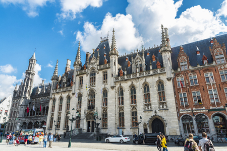Bruges, Belgium - August 31, 2017: The Provinciaal Hof (Province Court) and the Historium Brugge, on the market place of Bruges with people around in Belgiumのeditorial素材
