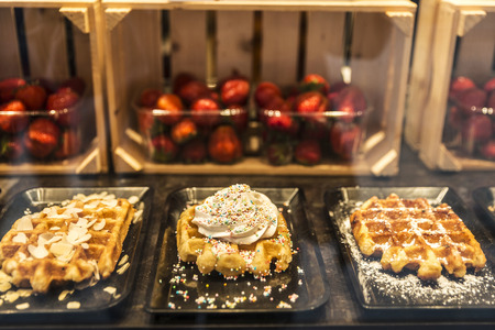 Display of a candy shop full of waffles in the medieval city of Bruges, Belgiumの写真素材