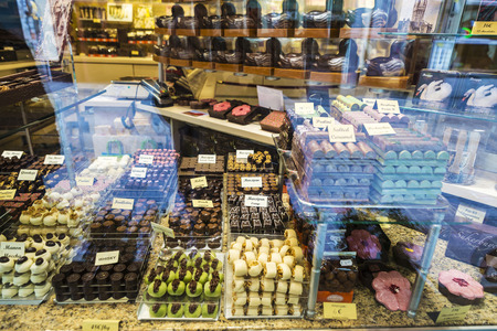 Bruges, Belgium - September 1, 2017: Assortment of traditional belgian chocolate in the shop window of a candy shop in in the medieval city of Bruges, Belgiumのeditorial素材