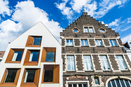 Facade of modern and old historic buildings in the medieval city of Bruges, Belgiumの写真素材