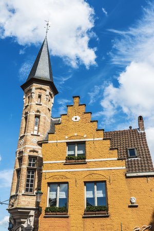 Facade of old historic buildings in the medieval city of Bruges, Belgiumの写真素材