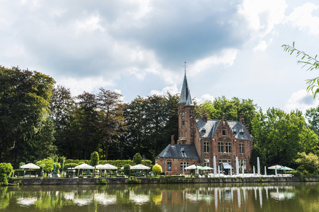 Bruges, Belgium - September 1, 2017: Old majestic mansion with its garden and terrace along the river in the medieval city of Bruges, Belgiumのeditorial素材