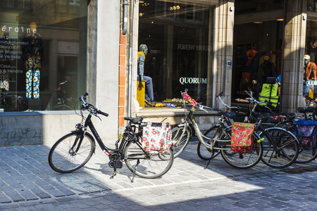 Bruges, Belgium - September 1, 2017: Street with bicycles parked in front of a Quorum store in the medieval city of Bruges, Belgiumのeditorial素材