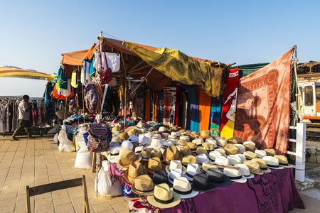 Castellammare del Golfo, Italy - August 6, 2017: Objects of all kinds in a souvenir shop highlighting panama hat in a flea market on a beach in Castellammare del Golfo in Sicily, Italyのeditorial素材